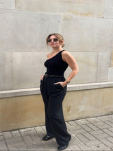 A girl wears a pair of black pants